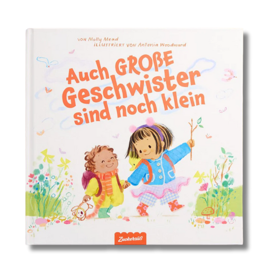 Zwei Kinder – eines mit lockigem Haar in einer gelben Jacke und das andere in einem blauen Kleid mit Zöpfen – lächeln, während sie gemeinsam auf dem illustrierten Cover von „Auch große Geschwister sind noch klein“, einem deutschen Bilderbuch des Zuckersüß-Verlags, spazieren gehen. Dieses herzerwärmende Kinderbuch beleuchtet auf einfühlsame Weise die Gefühle älterer Geschwister, während sie entdecken, was es bedeutet, Seite an Seite aufzuwachsen.
